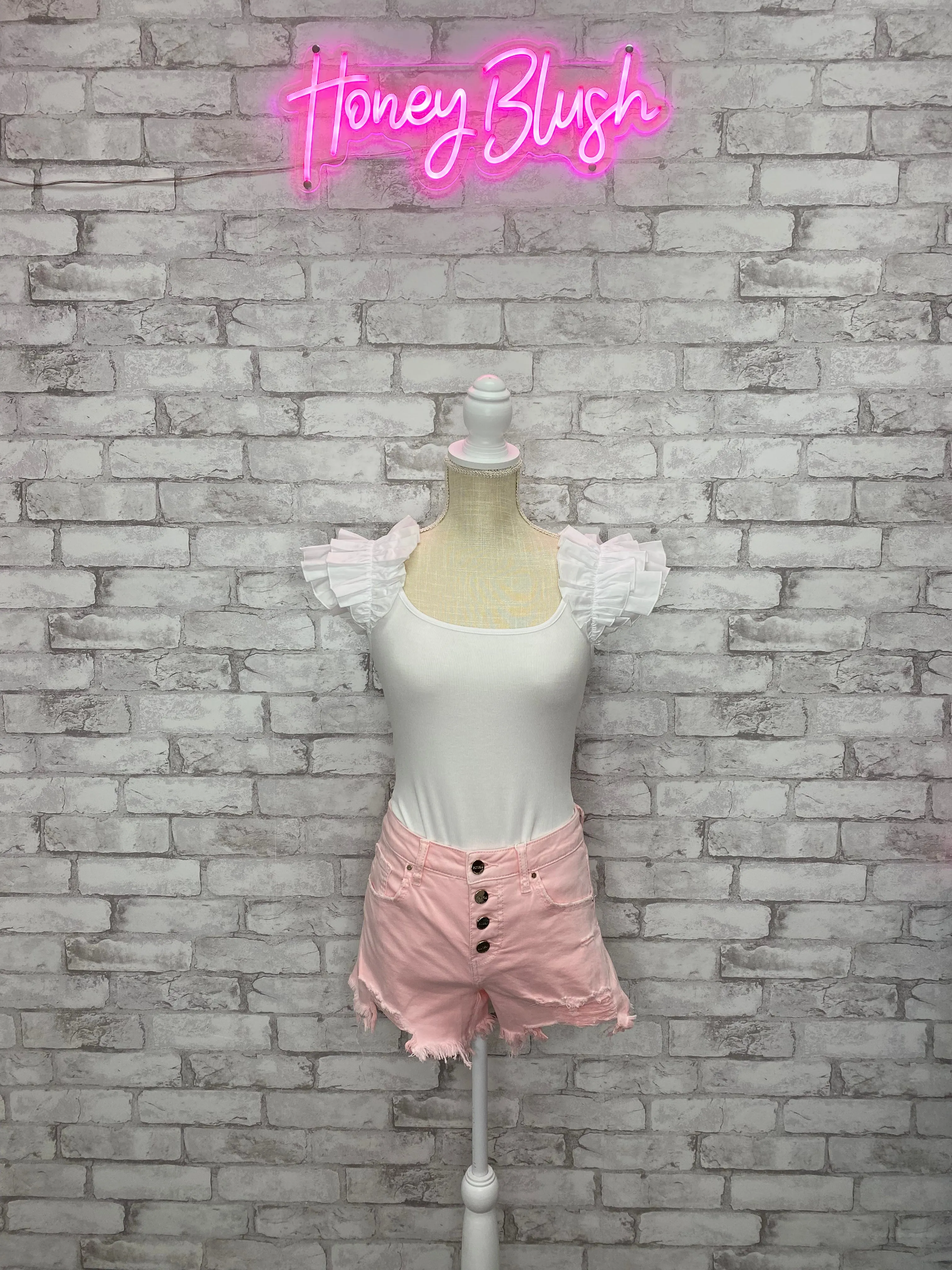 HIGH RISE BUTTON DOWN FRONT HEM DISTRESSED SHORTS